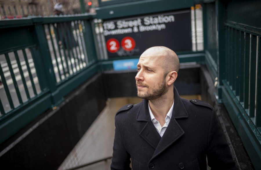 Portrait of Matt Wallaert '05 coming up from a subway stair. 