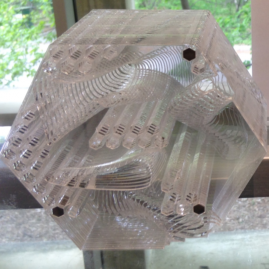 clear hexagonal sculpture with holes bored through it