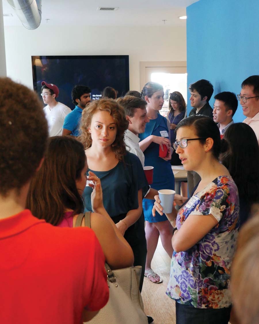 A group of people talking in a party setting