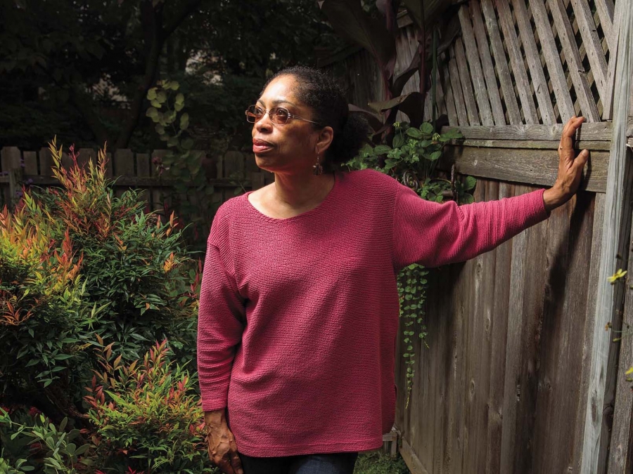 Photo of Syd Carpenter in a fuchsia sweater. 