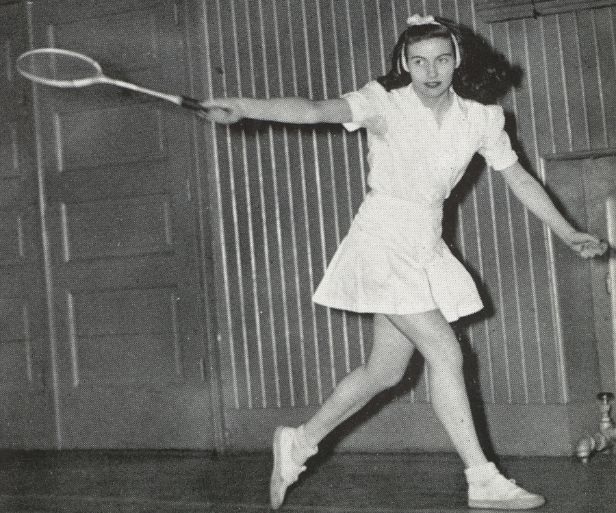 black and white photo of woman playing tennis