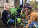 Erica Barks-Ruggles plants a tree with a native woman of Rwanda.