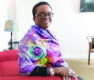 President Valerie Smith sits wearing a multicolored scarf