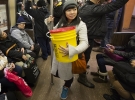 Rebecca Louie ’99 on a New York subway car with a 5-gallon bucket of compost