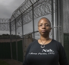 Erin Corbett ’99 stands in front of a prison