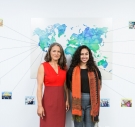 Morgan Simon ’04 and Jasmine Rashid ’18 standing in front of a world map