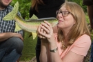 woman kissing a fish