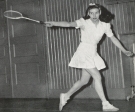 Gloria Evans Dillenbeck Dodd ’47 swinging a tennis racket.