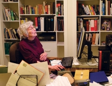 An older woman sits in an office with books. Christine Parker Ammer ’52 has turned her fascination with words into a career as a  lexicographer.