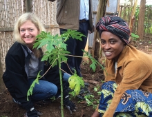 Erica Barks-Ruggles plants a tree with a native woman of Rwanda.