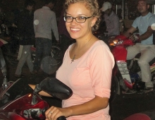 woman in glasses sitting on a motorbike