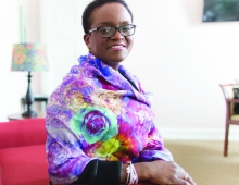 President Valerie Smith sits wearing a multicolored scarf