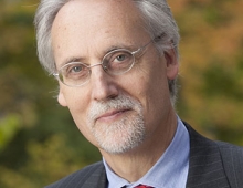 man wearing glasses and a suit and tie