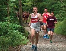 Runners run through the Crum woods.