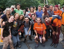 A group of smiling people take part in the People's Climate March in New York City.