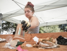 A female student sorting through trash