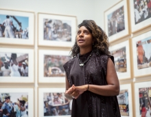 Zoe Whitley in front of photographs from her exhibition.