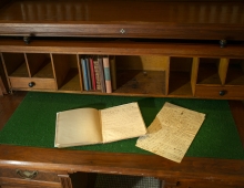 Joel Bean desk with open journals on top