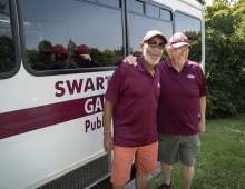 shuttle drivers in front of bus 