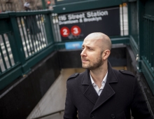 Portrait of Matt Wallaert '05 coming up from a subway stair. 