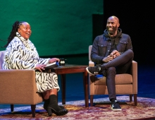 Prof. Nina Johnson and football player Malcolm Jenkins talk on a stage 