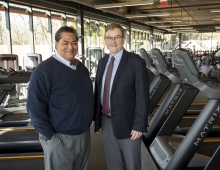 Varo Duffins and Jim Bock stand in a gym together 