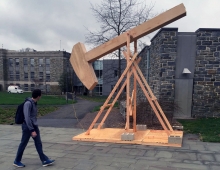 A wooden structure and a man on campus