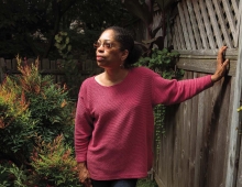 Photo of Syd Carpenter in a fuchsia sweater. 