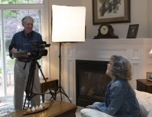 Ron Hurt ’67 and his wife Pam film a television episode in their living room.