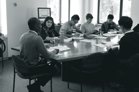black and white photo of professor and students in a seminar