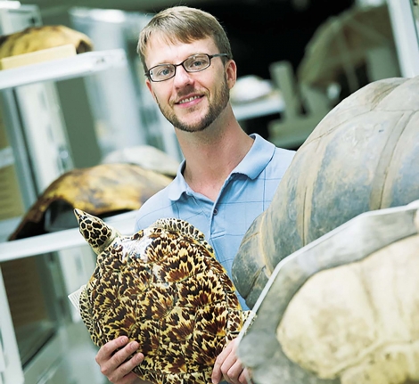  Tyler Lyson holding a Hawksbill sea turtle.