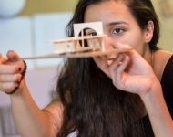 young woman looks up close at her model