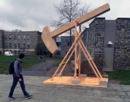 A wooden structure and a man on campus