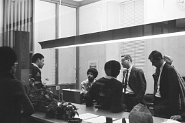 black and white photo of students speaking with administrators