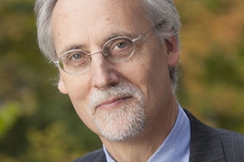 man wearing glasses and a suit and tie