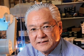 Joseph Takahashi ’74—Public Health Adviser is an older man with glasses and white hair looking at the camera. 