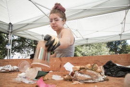 A female student sorting through trash