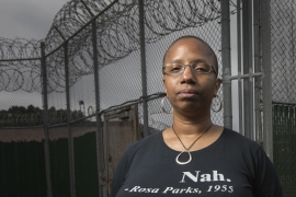 Erin Corbett ’99 stands in front of a prison