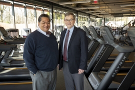 Varo Duffins and Jim Bock stand in a gym together 