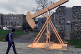 A wooden structure and a man on campus