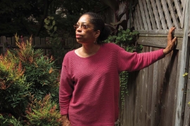 Photo of Syd Carpenter in a fuchsia sweater. 