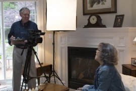 Ron Hurt ’67 and his wife Pam film a television episode in their living room.