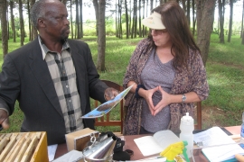 Susanne Weil teaching beekeeping with Edward Ochoro