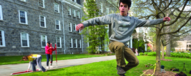 Swat Circus member Jonah Schwartz ‘15 leaps on a slack line on Parrish Lawn.