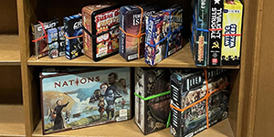 arrangement of board games on a shelf