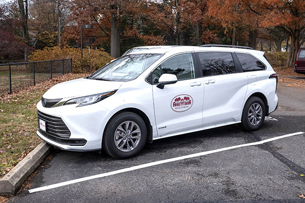 photo of white minivan with Swarthmore College logo