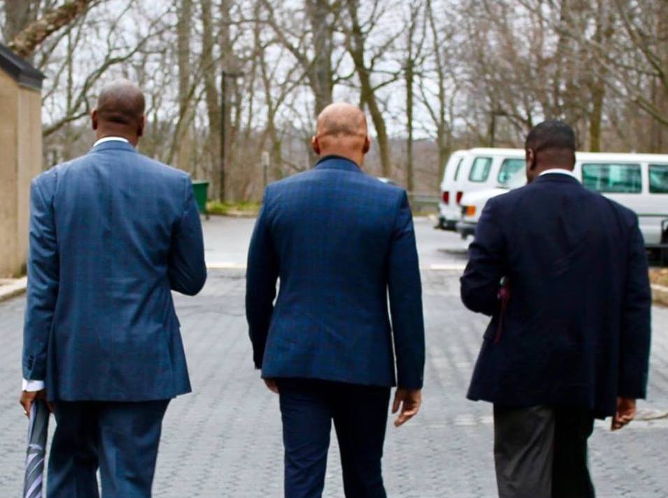 three men walking away
