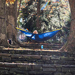 student in hammock on ampitheater