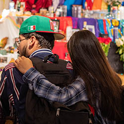 student with their arm on the shoulder of another student