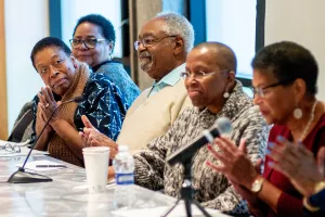 Five authors at a table